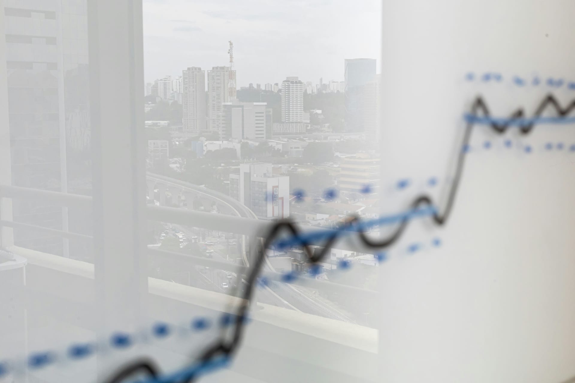 City skyline reflected on an upward growth chart, symbolizing scaling operations and capturing market share